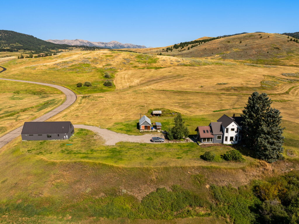 Aerial view of a winding road through a ranch property in rolling Montana hills