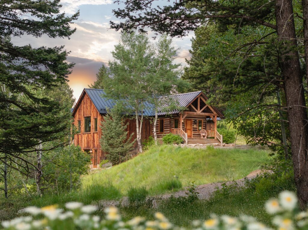 Luxury red mountain home surrounded by mature pine trees