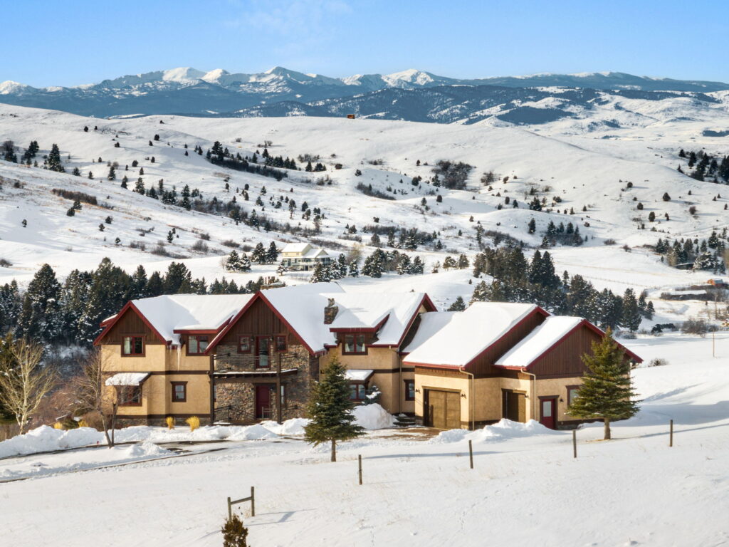 Snow-covered luxury mountain home with expansive views near Bozeman