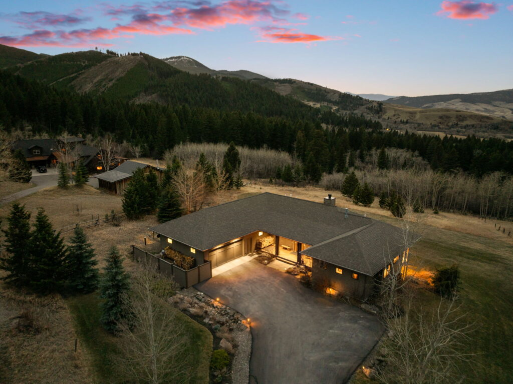 Aerial view of a luxury Montana residence at sunset