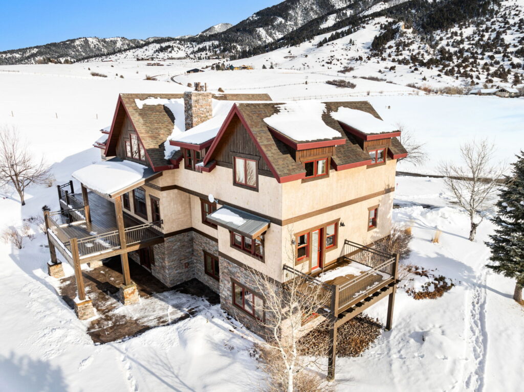 Aerial view of a snow-covered ranch home in Montana