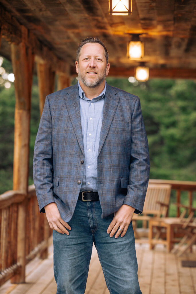 Brian Heck standing outside a Montana property in the Bozeman area